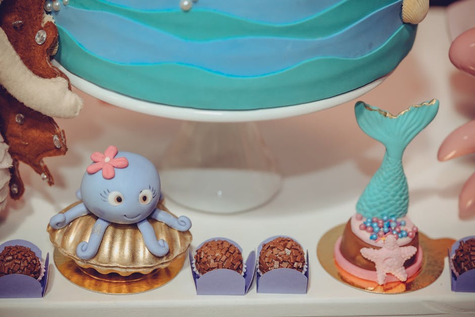 A charming underwater themed cake stand with octopus and mermaid decorations, perfect for ocean-inspired parties.