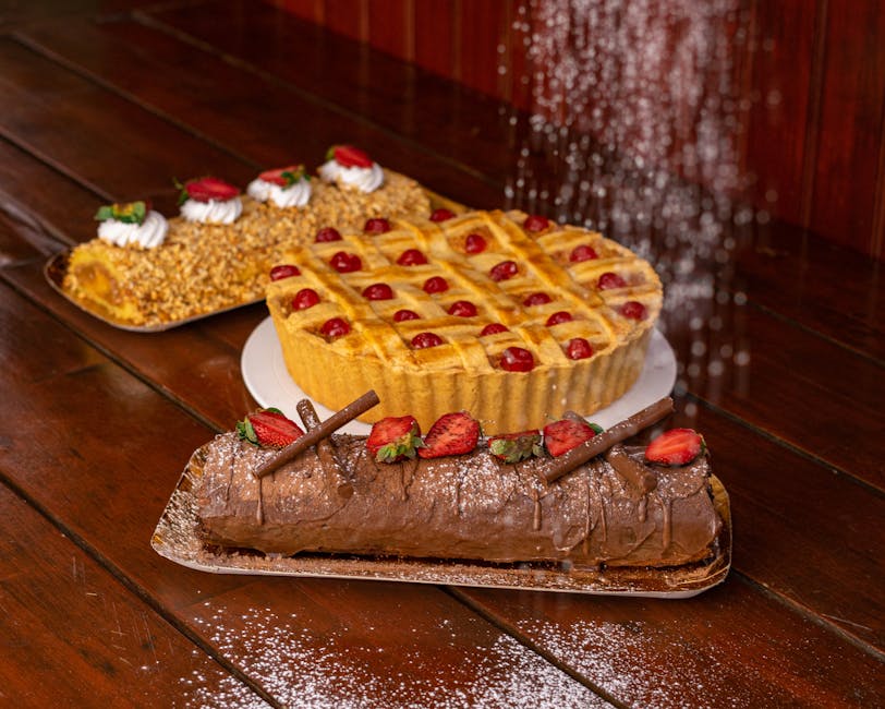 Delicious assortment of pies and cakes topped with fruit on a rustic wooden table.
