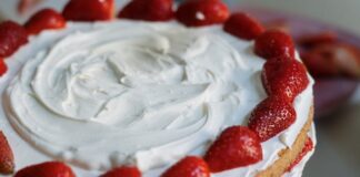 Mouth-watering strawberry cream cake with fresh toppings, perfect for dessert lovers.