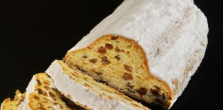 Sliced traditional German Stollen dusted with powdered sugar, perfect for dessert or breakfast.