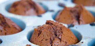 Delicious homemade chocolate cupcakes fresh out of the oven in a baking tray.