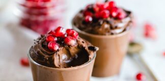 Luscious chocolate mousse topped with fresh pomegranate seeds, perfect for dessert lovers.