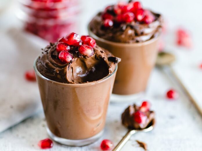 Receita de Mousse de Chocolate com Pepitas: Delicie-se no Natal! Luscious chocolate mousse topped with fresh pomegranate seeds, perfect for dessert lovers.