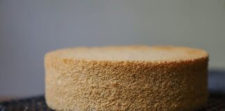 A plain sponge cake cooling on a wire rack, ready for decoration or serving.