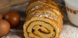 Tasty homemade Swiss roll cake surrounded by eggs and flour, perfect for baking enthusiasts.