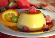 Pudim de Laranja: Receita secreta e deliciosa Indulge in creamy flan topped with raspberries, paired with citrus and caramel sauce for a delightful dessert treat.