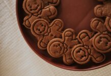 A close-up view of gingerbread men cookies arranged on a brown plate creating a festive atmosphere.