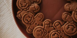 A close-up view of gingerbread men cookies arranged on a brown plate creating a festive atmosphere.