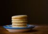 A stack of golden butter cookies on a ceramic plate, perfect for dessert inspiration.