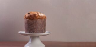 High-quality image of a traditional Italian panettone on a white cake stand.