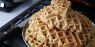 A close-up view of freshly made waffles on a plate, ideal for breakfast.