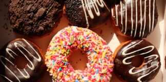 Bright and delicious donuts with sprinkles and chocolate, perfect for bakery promotions and dessert lovers.