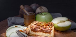 Close-up of a tasty apple nut cake with fresh green apples and walnuts.