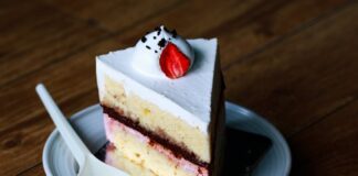 Indulge in this mouthwatering slice of strawberry cream cake, perfect for dessert lovers.